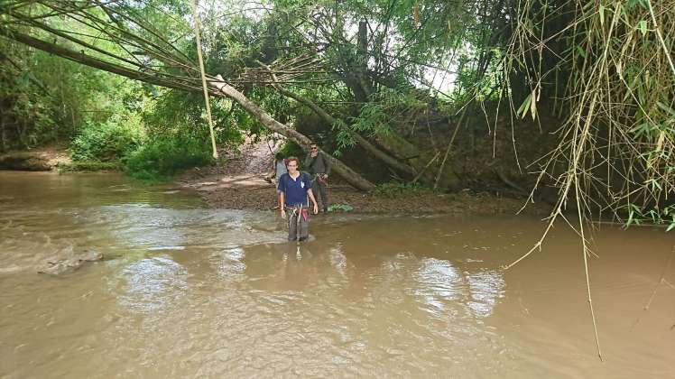 Wading through a River in the Jungle in Laos